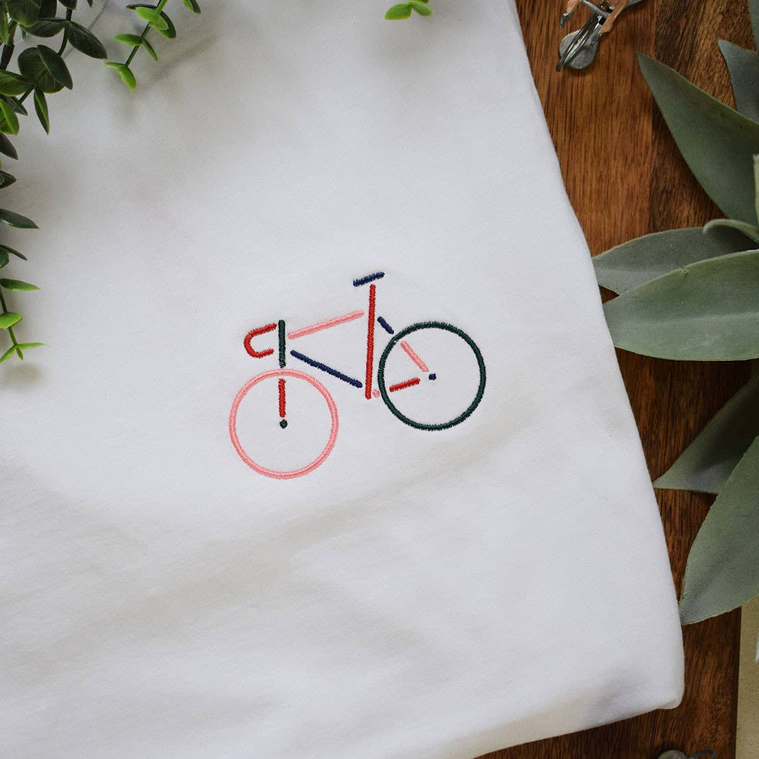 Weißes Unisex-T-Shirt mit mehrfarbig gesticktem Fahrrad